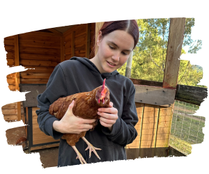 Volunteer Emma with rescued hen Purple at Farm Animal Rescue
