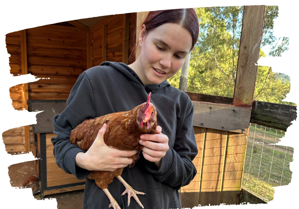Volunteer Emma with rescued hen Purple at Farm Animal Rescue